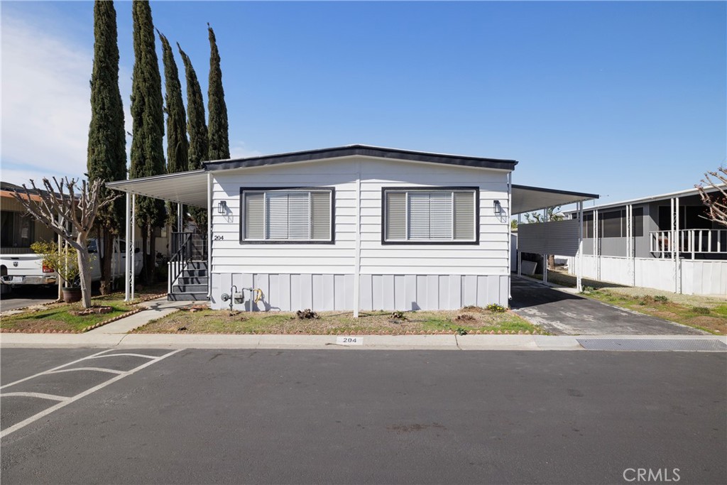 This beautifully remodeled home is situated in a great location in this amazing senior community!! This home features 2 bedrooms and 2 baths. The large kitchen is open to the large dining area. This beautiful home has been upgraded throughout. EVERYTHING is NEW. New counters, floors, fixtures...the list goes on! Even the exterior is freshly painted. The attached covered porch is very spacious and private too. You must see this one!