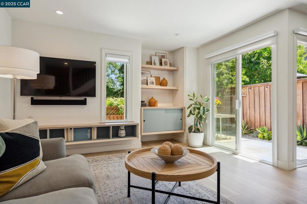 DO NOT MISS THIS ONE! Exceptional townhome close to downtown w/modern flair & designer finishes. Updated, contemporary vibe for today's discerning buyers. Wide-plank hardwood floors grace the main level. Fully remodeled kitchen w/light cabinetry, stainless appliances, quartz slab countertops, glass subway backsplash & storage pantry. Experience the seamless indoor-outdoor living from the kitchen, dining, & living room, where sliders open to create an expansive, airy environment. Abundant natural light.Custom built-in cabinets add function & style in the main living area. Enjoy the soothing & peaceful primary retreat w/built-in cabinets & fully remodeled luxurious ensuite bath. Guests will love the moody, cool powder room! Newer high-end W/D included. Private outdoor spaces include a charming entry courtyard & back patio perfect for alfresco dining. The patio opens to a lush, grassy common area flanked by majestic trees, providing the tranquility & nature often sought but rarely found. Your own private gate opens into this expansive common area ~ ideal for your dogs & kids to play. Lives like a detached home. Enjoy the ease of living close to town blending modern comfort w/the convenience of nearby shops, restaurants & hiking trails. Top rated schools.