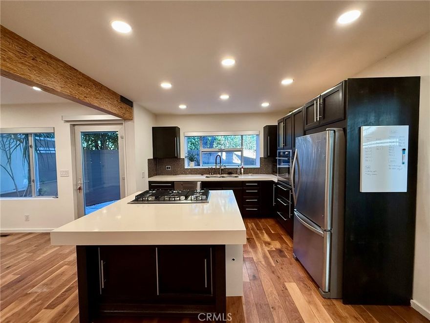 WALKABLE TO ABBOT KINNEY BLVD, this hidden Venice sanctuary is the gated lower unit of a contemporary duplex. Surrounded by bamboo and layered hedges, the 2-BEDROOM, 2-BATH home feels like a PRIVATE LANDSCAPED BUNGALOW WITH ITS OWN PRIVATE YARD AND ENTERTAINMENT DECK. A unique blend of modern design, privacy, and walkable convenience. The home features sleek hardwood floors, high-end doors and windows, and an open, airy layout that flows naturally to the outdoor spaces. The kitchen is outfitted with stainless steel appliances, including a refrigerator, microwave, dishwasher, washer, dryer, oven, range, and a spacious kitchen island paired with premium cabinetry. An XGIMI high-end projector and screen are also included with the unit. EV CHARGER PROVIDED. WATER SOFTENER INCLUDED. The unit also includes ONE DEDICATED PARKING SPOT TO THE ADJACENT PROPERTY and energy-efficient tankless hot water. Just blocks away from Venice’s best restaurants, cafés, and boutiques on Abbot Kinney—this is a rare opportunity to lease a truly special home in an iconic neighborhood.