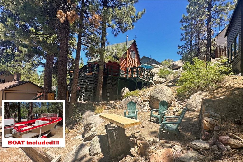 Charming Boulder Bay log cabin nestled beneath shady pines and tucked against a bed of grey boulders! FULLY FURNISHED and also includes a 16' 1962 Classic Sea King BOAT with TRAILER! Enter from the wrap around deck through the glass French door into a spacious living room featuring a cast-iron wood-burning stove, roll out SOFA BED and serene VIEWS of the lake and surrounding trees! The adjoining kitchen boasts an antique Wedgewood stove and comes fully equipped with a refrigerator, dishes and cooking supplies. The separate cozy dining area offers a ceiling fan and views of pine trees and large boulders on the adjoining slope. Interior laundry with included washer and dryer are next to the full bathroom with tub and shower. Upstairs, you’ll find a large bright and airy bedroom with wood accented walls, tall ceiling with a lighted fan, and several closets! Enjoy the outdoors from the wrap-around deck with BBQ, a bar top, and multiple seating areas including a lower landing and bar, all perfect for grilling and relaxing in nature! Additional features include forced air heating with a Nest thermostat, dual-pane windows, and a surveillance camera. A workshop and closet are conveniently located beneath the deck, and there's a parking pad right at street level. With hiking trails, the lake, Boulder Bay Marina and Big Bear Lake Village just minutes away, adventure and amenities are close at hand! Best of all, this cabin is sold fully furnished with a boat! Just bring your suitcase and settle in!