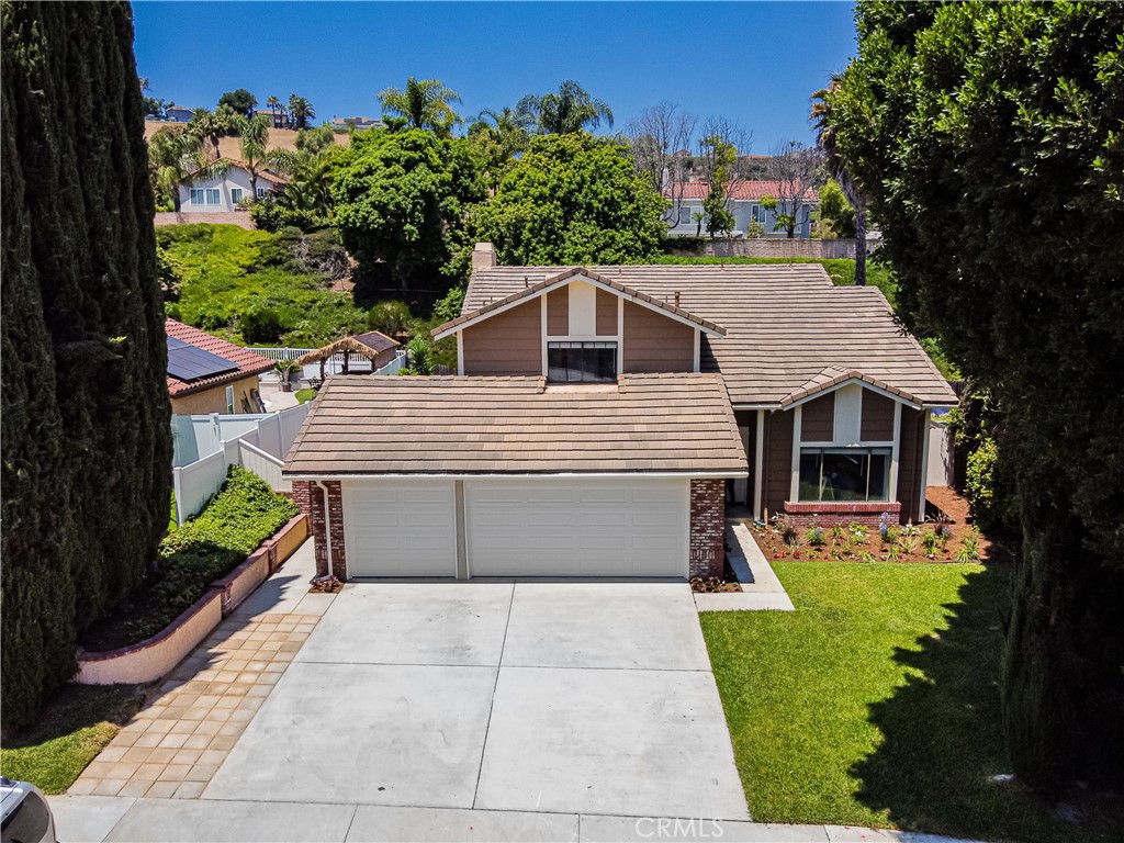 FOUR BEDROOM POOL HOME WITH DOWNSTAIRS BEDROOM AND ENTERTAINERS' BACKYARD! Situated on a cul-de-sac in a desirable Laguna Niguel neighborhood, this spacious home offers a generous lot featuring a sparkling pool, spa, and an expansive area ideal for entertaining or relaxing outdoors. Inside, soaring vaulted ceilings upon entry and abundant natural light create an inviting atmosphere throughout. The thoughtful layout includes formal living and dining rooms, a comfortable family room, and a cozy breakfast nook adjacent to the kitchen. The kitchen is appointed with elegant quartz countertops and offers views of the beautifully landscaped backyard.
The versatile floor plan includes a downstairs bedroom with private exterior access and a nearby bathroom with a walk-in shower—perfect for guests, extended family, or a home office. Upstairs, the large primary suite features a soaking tub, separate shower, dual sinks, and a walk-in closet. Two additional upstairs bedrooms are connected by a Jack-and-Jill bathroom, offering both space and privacy.
Recent enhancements add both comfort and style, featuring fresh interior and exterior paint, tile flooring on the main level, new carpet upstairs, updated blinds throughout, and a complete PEX repipe. The lush backyard showcases a sparkling pool and spa surrounded by vibrant rose bushes, mature greenery, and four fruit trees, while the front yard is equally well-maintained and inviting.
Conveniently located near schools, parks, shopping, and more, this home combines space, functionality, and charm in one of Laguna Niguel’s most sought-after communities.