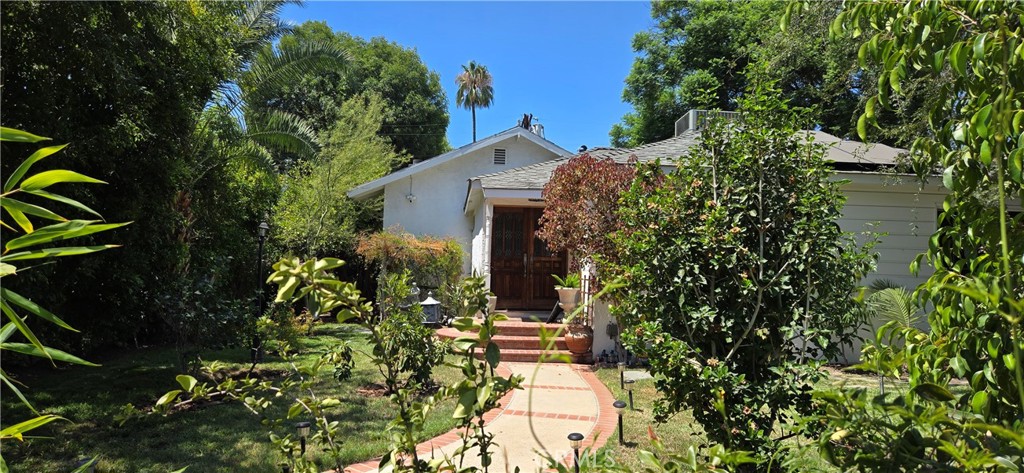Lake Balboa area of Van Nuys. This home provides many amenities. Enter through the double doors into your new home with a lovely chandelier hanging in the entryway and the living room off to the side. Nice wood floors continue into the hall and bedrooms. One is being used as an office. Both of the bathrooms have been rehabbed. In the hall bathroom the special lighting has different colors which provide various health benefits, red for healing and blue to keep away mold and bacteria. It has a cast iron tub to relax and listen to music. If you walk staight through from the entry, you'll walk into a kitchen with a Wolf stove, new vent hood, cabinets redone by hand, and granite counters. Travertine tile floors are in the kitchen, dining area, and famiy room. A beautiful, large fireplace with a mantle showcases the family room for putting your prize possesions out for show. Double pain windows with privacy tinted glass and no exterior noise. Shutters to block out the sun. New A/C and Solar by Sunrun. Plumbing and electrical panel all new. The 2 car oversized garage has a tiny kitchen & bathroom, not being used. This home is close to the 405 & 101 frwys, Sepulveda, Sherman Way, and Van Nuys Blvd, if you don't want to use the freeway. It's not far from the Burbank Airport, Topanga & Northridge Malls, Six Flags, Universal Studios, Cal State Northridge, train station and more.