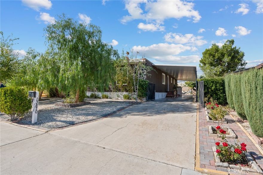 Welcome to this beautifully maintained 2-bedroom, 2-bath manufactured home nestled in the center of Victorville — close to shopping, dining, and all city conveniences! This home sits on its own land, offering both comfort and independence without park fees. Step inside and be greeted by bright natural lighting, beautiful tile and laminate floors, and tastefully finished walls that create a warm and inviting atmosphere. The spacious living and dining areas flow perfectly for entertaining or relaxing, while the well-designed kitchen offers plenty of cabinet space and functionality. Enjoy the convenience of a dedicated laundry room and two full bathrooms that are clean, and well cared for. Outside, you’ll find beautiful landscaping that enhances the home’s curb appeal, a carport for covered parking, and two storage sheds—perfect for tools, hobbies, or extra storage. The backyard is private, well-kept, and ideal for outdoor gatherings or simply relaxing in your own peaceful retreat. Surrounded by lush fruit trees in the back and 2 large pepper trees in the front for shade. Connected to public sewer and located on a quiet street, this home offers a wonderful blend of city living and suburban comfort. Don’t miss the opportunity to own this lovely, move-in-ready home in one of Victorville’s most convenient locations!