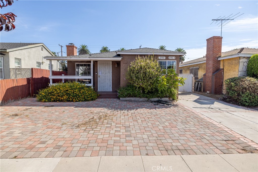 Updated and well-maintained, this Long Beach duplex offers comfort, functionality, and strong rental potential. The property consists of two units: the front home at 2740 Easy Ave features 946 square feet with 2 bedrooms and 1 bathroom, while the rear unit at 2740A Easy Ave provides 480 square feet and 1 bedroom and 1 bathroom—ideal for multigenerational living or steady income. Both residences include remodeled kitchens and bathrooms with charming finishes, hardwood flooring, and bright, efficient layouts. A gated driveway leads to a detached two-car garage with laundry, shared yard space, and full perimeter fencing. A front porch creates inviting outdoor spaces for both households. The garage comes with fully approved plans for conversion into a third unit ADU, giving the next owner immediate value-add potential. This is a solid residential income opportunity in a central Long Beach location. With move-in ready interiors, approved development upside, and existing rental income, 2740 Easy Ave is well suited for owner-occupants seeking supplemental income or investors looking for a strong long-term hold.