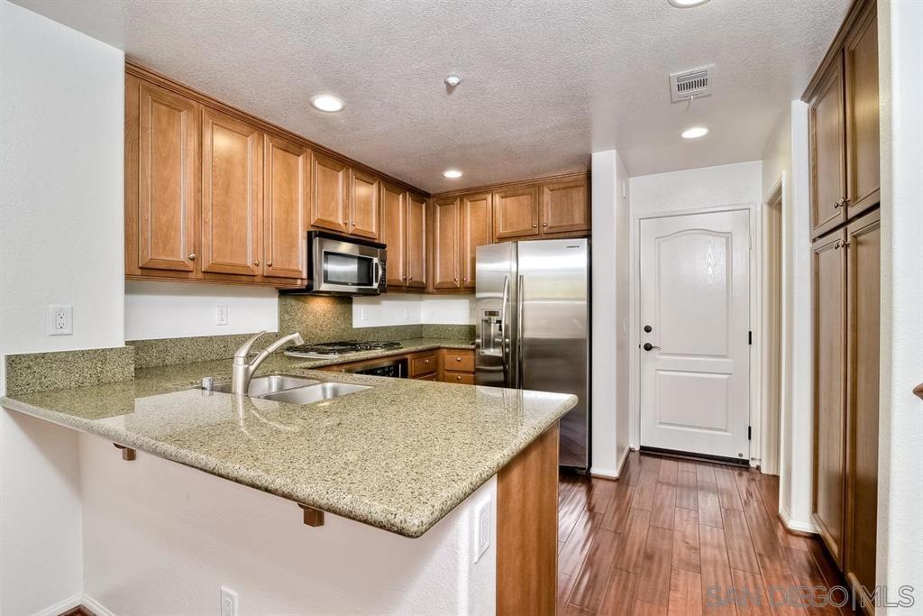 This Lovely 2-Story Gianni Townhome in 4S Ranch, has a lay out that feels like a single family home! - Great Location-Very Quiet, No Building in Front of unit- Granite Kitchen Counter-tops, Stainless Steel Appliance, Upgraded Distressed Hardwood Flooring all downstairs,Large Master Bedroom w/ Walk in Closet - Tile floors in Master Bath with Double Sinks & a Big Tub/Shower - Hall Bath Double Sinks & Big Tub/Shower - 2 Car Side by Side Attached Garage w/ Epoxy Flooring-Washer/Dryer and Refrigerator Stays! Access to Award Winning Poway Schools! Walk to Stores, parks, and restaurants. Don't Miss this one! You Get Access to POWAY SCHOOLS! Walking Distance to the stores, Beautiful Parks, shops, and the Schools.