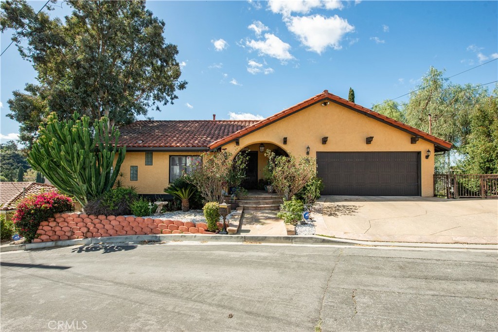 Welcome to this jewel of a house for lease in the desirable South of the Blvd area of Woodland Hills, spanning nearly 3000 sq ft tucked away in a cul de sac, it boasts spectacular views of Santa Monica Mountains from the sweeping patios in the back. This single-family residence is minutes from The Commons, Topanga Village, and Calabasas with shopping, dining and parks. Assigned to the Woodland Hills Charter Elementary for Enriched Studies and Taft Charter High School. The front entrance on secluded San Blas Ave welcomes you to the spacious open floor plan of the upper level, which includes living areas seamlessly inviting outdoor dining through the French doors to the patio. Downstairs includes a spacious den ideal for movie night and a broad patio for entertaining or reading on a relaxing afternoon. Large windows throughout the home on both levels provide an abundance of natural light and sweeping views from any angle in the house (including while washing the dishes in the kitchen). The kitchen is equipped with built-in appliances and ample storage. The large primary bedroom has its own bathroom with jacuzzi tub, separate shower, and double sinks. In all, the home features 4 generously sized bedrooms and 3 modern bathrooms, including an office with custom built-in shelves.
It is Tuscany in Woodland Hills at this open yet secluded oasis surrounded by cypress trees, house painted in orange ice, to match the inspiring sunrises and sunsets around it.
