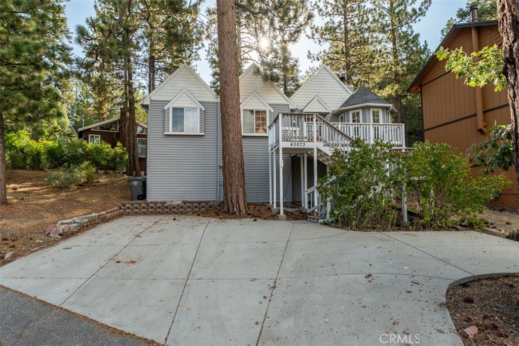 Live Auction! Bidding to start from $449,000! An Exceptional Opportunity to own a charming 3-bedroom, 2-bath Big Bear Lake retreat, perfectly blending mountain character with modern comfort! This spacious home features vaulted ceilings, chair rail accents, and a welcoming front balcony to soak in the fresh alpine air. The inviting living room showcases a classic brick fireplace and a cozy bay window enclave, seamlessly opening to the kitchen and dining area—ideal for gathering with family and friends. The kitchen offers warm wood cabinetry, a center island, and tasteful tile countertops and backsplash. All bedrooms are generously sized, including a large primary suite with a private full bath, while a second full bath serves the additional bedrooms. Step outside to a large back deck, perfect for entertaining or relaxing after a day of adventure. This home also includes a walk-in basement with extra storage, perfect for stowing away all your outdoor and recreational gear. Designed with both comfort and convenience in mind, the property comes equipped with modern smart-home technology and an electric car charger, making it as functional as it is inviting. The warm character of this mountain retreat reflects years of cherished family memories, ready to be passed on to its next owner. With ample parking in the driveway and a location less than a mile from Bear Mountain Ski Resort, Bear Mountain Golf Course, and the Big Bear Zoo; and just 10 minutes to Big Bear Lake, shopping, and dining—this move-in-ready home is the perfect mountain getaway or investment property, which is sure to please!