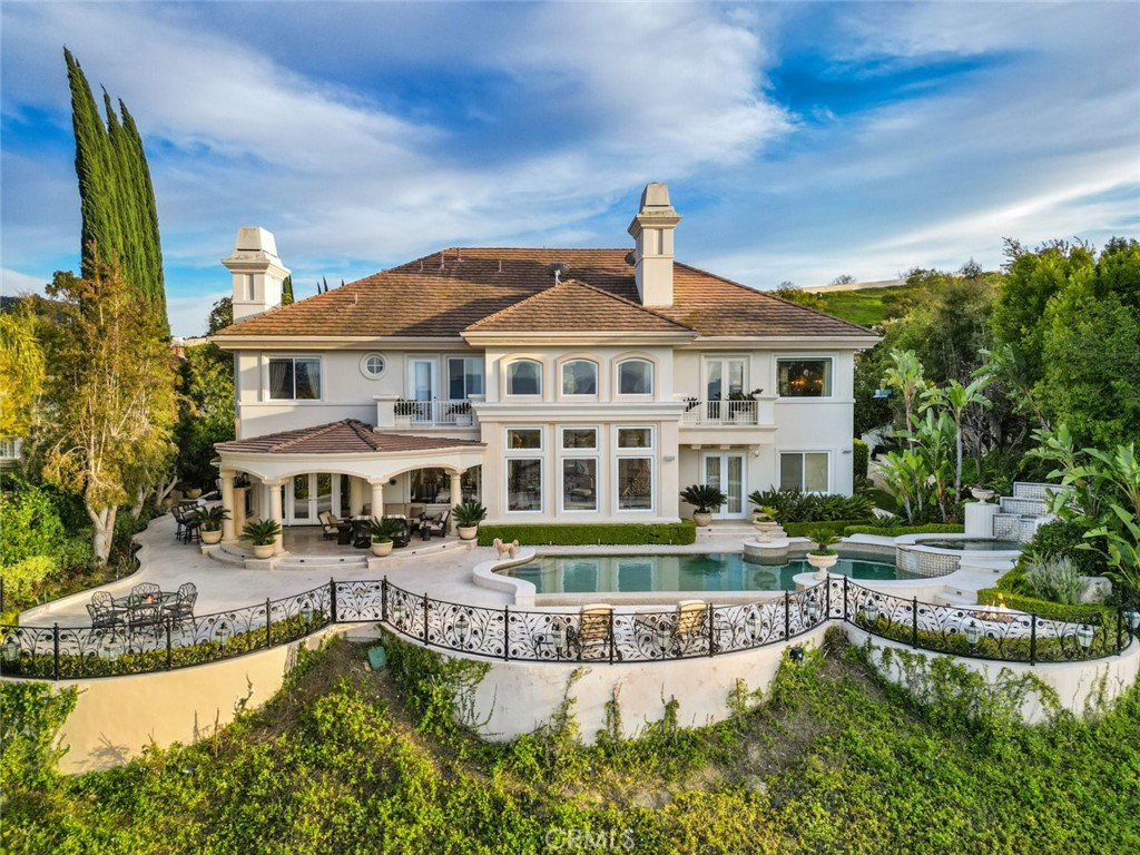 Updated August 1st, tenant just moved out and easy to show! Prepare to fall head over heels for this exceptional fully furnished lease opportunity in the esteemed Mulholland Park, the most prestigious 24-hour guard-gated and patrolled community! Welcome to 3724 Winford Drive, where luxury and comfort intertwine seamlessly in this breathtaking home. Boasting 5 bedrooms and 8 bathrooms sprawled across 6,549 square feet of living space on an expansive 17,762 square foot lot, this residence is a true gem. As you enter through the double doors, you'll immediately be struck by the splendor of soaring ceilings and dual staircases leading to the second floor. The living room invites you in with its bright and spacious ambiance, complemented by floor-to-ceiling windows offering panoramic views and a cozy fireplace for added warmth and allure. Adjacent to the living room, the formal dining area and kitchen await, meticulously designed for both practicality and elegance. The kitchen is equipped with Viking appliances, a Subzero refrigerator, a large island, granite countertops, and ample storage space, catering to the needs of culinary enthusiasts. Additionally, a family room with its own fireplace offers a serene space for gatherings and relaxation on the first floor. This magnificent home encompasses a grand master bedroom, bathroom, and dual walk-in closets with built-in custom cabinets, occupying half of the entire second floor! Additionally, there are four generously sized bedrooms, each with its own private bathroom, ensuring comfort and convenience for residents and guests alike. But the extravagance doesn't end there. Step into your custom cigar room, where luxury meets functionality. With a humidor and ventilation system, indoor smoking becomes a refined experience. Adjacent, a meticulously curated wine cellar awaits, complemented by built-in speakers for added ambiance. And for entertainment fans, indulge in movie nights in your private theatre, ideal for gatherings or your next sporting event party. Head outside to discover your own private oasis in the expansive backyard with amazing views, perfect for outdoor entertaining and relaxation. Featuring a sparkling heated pool and spa, fire pit, basketball court, patio, and barbecue area, this outdoor haven offers endless possibilities for enjoyment. Don't miss the opportunity to make this exceptional property your own and experience the epitome of luxury living. EV charger available!