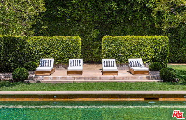 Exquisitely positioned European villa in prime Beverly Hills Flats. This is a unique opportunity to acquire a rare, approximately over half an acre property in the prime 700 block of the Flats. Private gates open to an elegant entryway. Elevated ceilings and floor to ceiling French doors surround the main level. Chef's kitchen equipped with Viking appliances and butchers block island. Grand dining room with polished wood floors, family room, and cozy study with fireplace make up the main level. Enter the backyard through the veranda to the pool and spa. Formal parterre gardens surround the separate guest suite. The expansive park-like setting is reminiscent of the French countryside. This estate is European elegance at its finest.