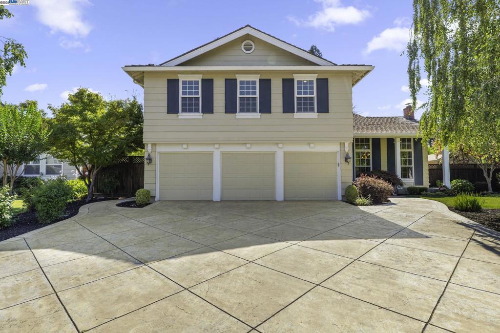 Located in San Ramon's prestigious Inverness Park, this beautifully remodeled 4-bed, 3-bath home offers one of the neighborhood's most desirable locations—adjacent to open space and picturesque walking trails. The entry showcases a dramatic winding staircase, setting the tone for the elegant design throughout. A formal dining room sits to the right, while a versatile downstairs bedroom/office is to the left. The heart of the home is an expanded kitchen and family room featuring a large quartz island, Thermador range, KitchenAid double ovens, Electrolux column fridge/freezer, walk-in pantry, and a full beverage center with wine fridge, kegerator, and more. A sprawling backyard oasis featuring a sparkling pool, a waterfall feature, a spacious hot tub, a built-in grill station with eating bar, covered gazebo, mature landscaping and raised beds create a resort-style atmosphere. Upstairs offers 3 bedrooms, 2 updated baths, and a spacious bonus room with potential for additional bedrooms. Additional upgrades include luxury vinyl plank flooring, crown molding, a remodeled 3-car garage with epoxy floors and cabinetry, and solar for both home and pool. Close to top-rated schools, the Iron Horse Trail, and freeway access. Open House Sat and Sun 1-4.