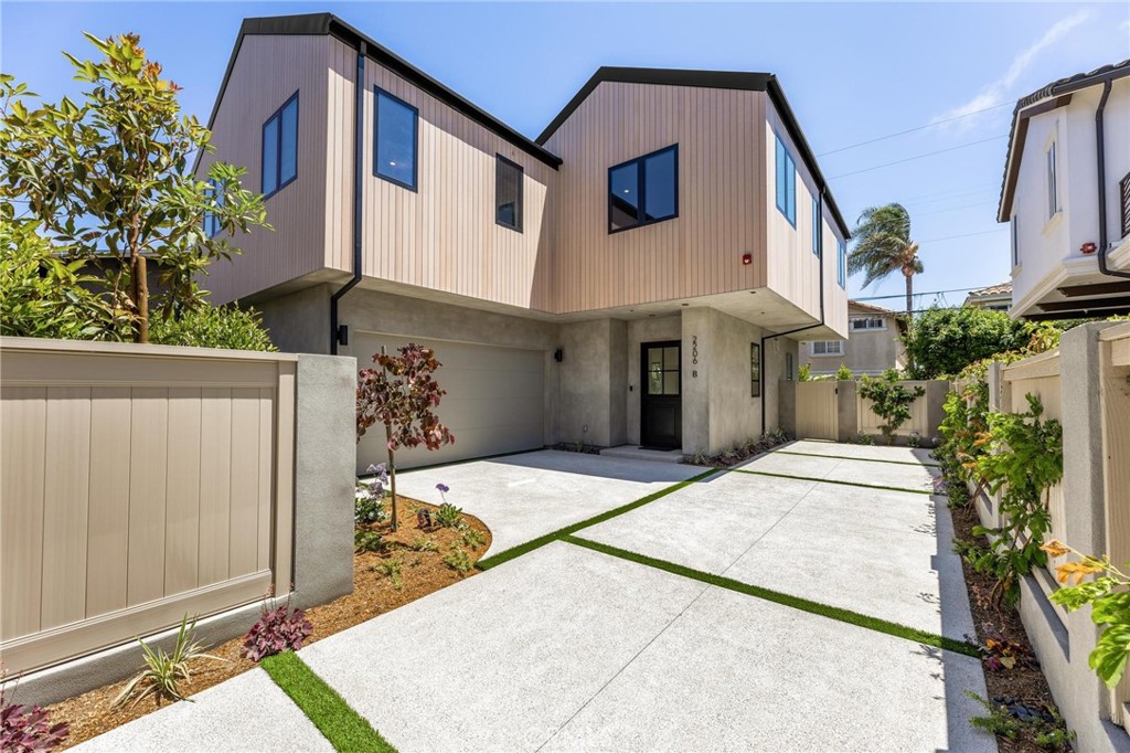 *Back & Front Unit Available - Garage Included in the SQFT* — Welcome to 2206 Gates Avenue, a stunning showcase of modern luxury on one of North Redondo Beach’s most prestigious streets. This custom residence is part of an exclusive new development featuring two detached townhomes—each sold individually—designed by world-renowned architect Hsu McCullough, as seen in Architectural Digest. Set on a large 7,501 sq. ft. lot, this home offers the privacy and feel of a single-family residence. Enter through a charming Dutch door into a light-filled, open-concept main level with a full-height limestone-veneered fireplace. Dual sliding glass doors open to a completely private backyard and patio, creating seamless indoor-outdoor flow. The chef’s kitchen features an oversized island with bar seating, a large farmhouse sink with Rohl faucet, custom Italian Cleaf cabinetry, Thermador appliances, six-burner range with hood vent, and premium Taj Mahal quartzite counters and backsplash. Large pantry, storage closet off the direct access garage, and a powder room add convenience. The main level also includes recessed lighting, built-in surround sound and "Alexa" controlled "smart home" features. The oversized two-car garage offers built-in storage and direct access to the home. Upstairs, a light oak staircase leads to the expansive primary suite with vaulted ceilings, exposed beams, fireplace, and a private balcony overlooking the yard. The spa-inspired ensuite features a freestanding soaking tub, double sink vanity, rainfall shower with skylight, private water closet, and a skylit walk-in closet with built-ins and a makeup vanity. Also upstairs: a laundry room with sink and storage, a bright junior suite with custom built-ins and ensuite bath, and two additional bedrooms with generous natural light and mountain views. A secondary upstairs bath includes a tub/shower combo and a private water closet. Additional features include solar panels, full home automation system (cameras, HVAC, lighting, music), high-efficiency HVAC with sleek linear vents, durable upcycled siding, and a metal roof for low-maintenance protection. The rear yard offers a serene space for al fresco dining, entertaining, or relaxing. 2206 Gates redefines luxury living through impeccable design, smart innovation, and elevated functionality—offering a rare opportunity to own a truly exceptional residence, and access to Mira Costa High School, in one of North Redondo Beach’s most desirable neighborhoods.