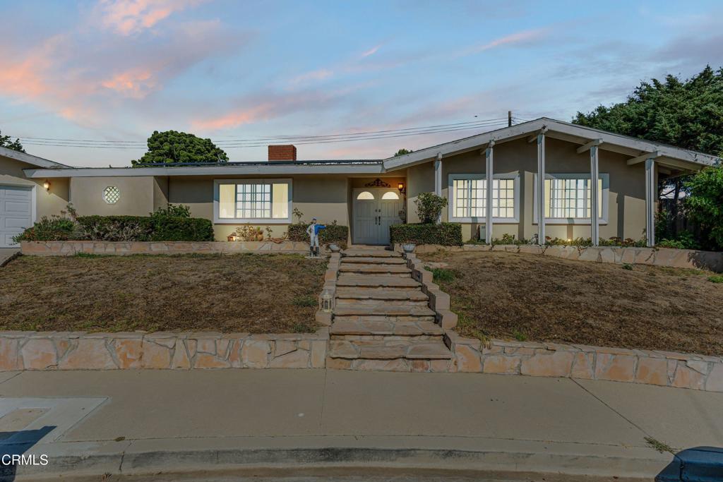 Welcome to this stunning single-story residence in Ventura, offering 2,289 sq ft of thoughtfully designed living space on a generous 10,454 sq ft lot. With 5 bedrooms and 3 full bathrooms, this home blends comfort, functionality, and modern style in a highly desirable location.Step into the inviting living room, where warm cherry-toned floors and a cozy fireplace create an ideal space for relaxing or entertaining. The gourmet kitchen features crisp white cabinetry, a center island, ceiling-mounted pot hangers, stainless steel appliances, and a double oven, perfect for the home chef.Adjacent to the kitchen, the dining area boasts its own fireplace and direct access to the backyard, where you'll find a refreshing pool, a picturesque shell feature, grassy and paved areas, and a brick-built barbecue, perfect for outdoor gatherings or peaceful afternoons.The spacious primary suite offers a mirrored closet and an en-suite bathroom with timeless design elements. Additional features include a dedicated laundry room, a two-car garage, and a wide driveway with ample parking space.Located in a quiet, established neighborhood, this home is just minutes from top-rated schools, beautiful parks, scenic hiking and biking trails, and Ventura College. Enjoy the convenience of nearby amenities while living in a peaceful and private setting.Don't miss the opportunity to make this exceptional Ventura home your own!