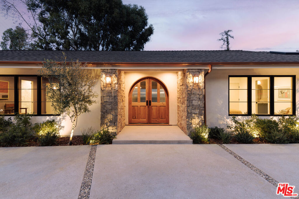 Nestled in the hills of Studio City, this gated modern European-style home exudes timeless elegance and contemporary charm with unobstructed views of the valley. Spanning 3,515 square feet, the open-concept layout seamlessly blends spacious living areas, creating an ideal flow for both entertaining and everyday living. The home features five generously sized bedrooms and 4.5 luxurious bathrooms, each appointed with natural stone finishes that complement the home's sophisticated design. The smooth stucco exterior is complemented by sleek brass gutters, creating a striking contrast with the neutral tones and modern lines of the architecture. Inside, European white oak hardwood floors run throughout, bringing warmth and texture to every room. The combination of natural stone finishes and a soft color palette adds to the home's sense of refined simplicity, while large windows flood the interiors with light, offering views of the surrounding greenery. This residence offers the perfect balance of modern luxury and European-inspired design. Additional features include built in speakers, tankless water heater, all new plumbing and electrical, pebble tec finished pool, outdoor shower, lutron light system, circular driveway and all new hardscape/landscape. This is one you won't want to miss!