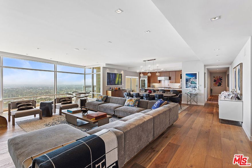 Welcome to this exceptional three-bedroom, three-and-a-half-bath residence perched on the 23rd floor of The Century, a prestigious 42-story, LEED-certified architectural landmark by renowned architect Robert A.M. Stern. From the moment your private elevator opens, you're greeted by floor-to-ceiling windows framing panoramic jetliner views from Downtown Los Angeles to the Pacific Ocean. Every room has been impeccably designed with sophisticated finishes and top-tier materials, offering the pinnacle of high-rise elegance.The expansive open-concept living and dining area flows seamlessly to two south-facing covered terraces, perfect for alfresco dining or lounging high above the city. The chef's kitchen is outfitted with premium Sub-Zero and Miele appliances, cabinetry, and sleek countertops. Each of the three bedrooms features its own en suite bath, blackout shades. A discreet laundry room with a separate service entrance adds to the home's thoughtful design. The fully integrated home automation system controls everything from motorized window treatments to state-of-the-art AV systems. Residents enjoy five-star amenities, including a 75-foot pool, fitness center, spa treatment room, private wine storage, dog park, and lush walking paths. The building offers 24-hour valet, concierge, and doorman services, delivering unparalleled convenience and security. Discover refined living in the heart of Century City  where sophistication meets service and design meets distinction.