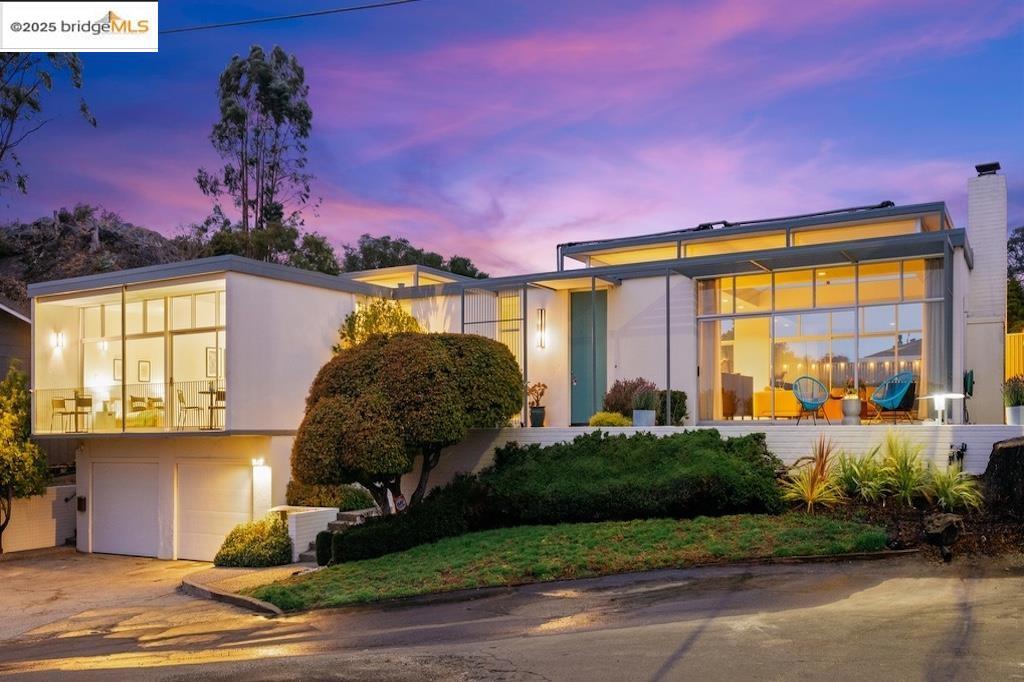 Designed in 1963 by acclaimed architects Campbell and Wong, 7145 View Ave is a striking mid-century modern that channels Palm Springs style. Set on a generous 10,890 sq ft cul-de-sac lot, this 2,967 sq ft home captures Bay and bridge views through walls of glass. All the living space is on one level, with 5 beds, 3 baths, radiant-heated cork and tile floors, and a layout ideal for both daily living and entertaining. Clerestory windows extend the height of the rooms and increase the light. Interior courtyards and lush outdoor spaces, sheltered from the wind, invite year-round enjoyment. At the center, a solar-heated large lap pool flows directly off the living, dining, kitchen and family room areas as well as the primary bedroom, creating a true indoor-outdoor resort feel. The oversized two-car garage offers abundant storage and an EV charger. Lovingly maintained since 1996, with upgrades including solar power, updated kitchen and bathrooms, this rare architectural property is minutes from hiking, parks, and BART—offering style, comfort, and connection in one stunning package.