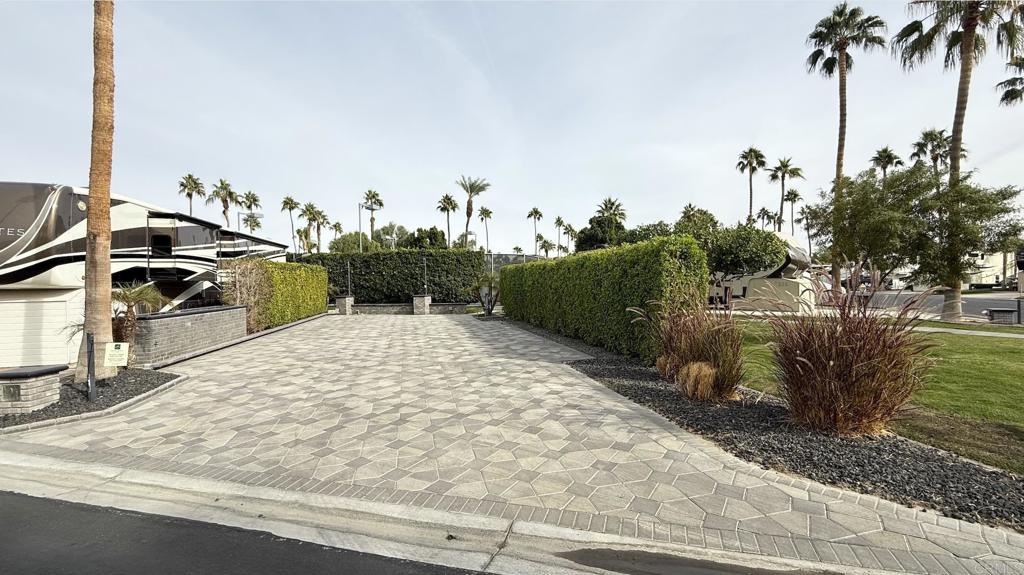 Lot 101, This spot has every feature you would want: beautifully paved, firepit, up against your own satellite with pool, jacuzzi, washer/dryer and shower facilities. Privacy hedges on each side. The care in construction shows the love put into it. Outdoor Resort Palm Springs (ORPS) is a Guard Gated 5-Star RV Resort Community offering an active and luxurious lifestyle featuring golf (27 holes), tennis, pickleball, swimming and more! Two clubhouses, fitness center, beauty solan, La Roma Restaurant on campus, dog park and more!
