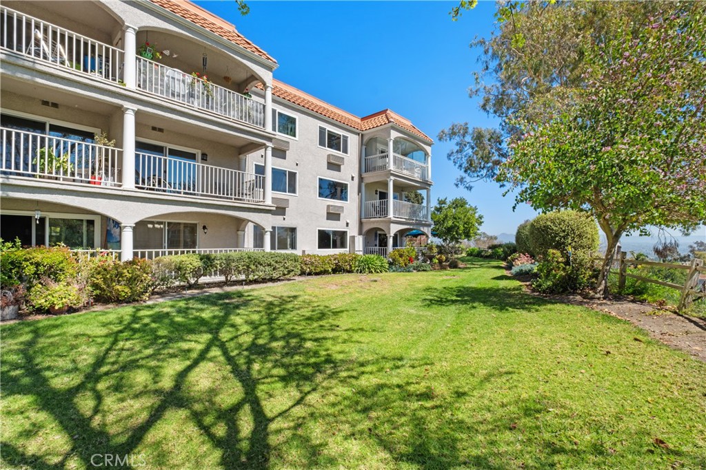 BEAUTIFUL & NEWLY REMODELED WITH HIGH QUALITY DESIGNER FINISHES AND FIXTURES THROUGHOUT! PREMIUM & PRIVATE LOCATION WITH SCENIC VIEWS!! Highly desired 2 bedroom and 2 bathroom Condominium (Villa Nueva model) located on top of a hill in the prestigious Gate 14 entry! Premium location with total privacy and walk-in level with no stairs, this first floor Villa Nueva model enjoys gorgeous views of the lush common area greenbelt, hills, and city lights! Beautifully updated turnkey home with warm neutral color tones and spacious open floor plan. The upgraded kitchen features new countertops, recessed lighting and quality appliances. A long list of upgrades include beautiful and modern luxury vinyl floors and baseboards, upgraded bathrooms, new light fixtures, window coverings and new interior paint throughout to name few. This unit is situated in very close proximity to the covered carport space (there are no stairs from the parking area to access this unit). Laguna Woods Village is a wonderful 55+ community with state of the art amenities, golf courses, social clubs, bocce ball, swimming pools, walking trails, tennis courts, clubhouses, and so much more!!