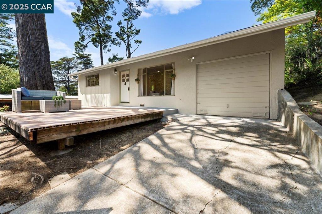 Welcome to your private bungalow retreat. This single-story, 2-bedroom, 1-bathroom upgraded home features new LVP flooring, fresh paint, and an updated bathroom. The eat-in kitchen is modern and ergonomic, with brand-new stainless steel appliances, custom cabinetry, and quartz slab counters. An open flow from the kitchen to the living space and outdoor deck enhances natural light and airflow. The spacious attached garage offers additional storage solutions or potential expansion opportunities. A long tandem driveway provides parking for 2–3 cars. The property sits on a generous double-sided lot with level yards and convenient access from both Evergreen Ave and Forestland Way. This home is an excellent opportunity for first-time buyers or downsizers seeking a quality property in a highly sought-after Oakland Hills neighborhood.