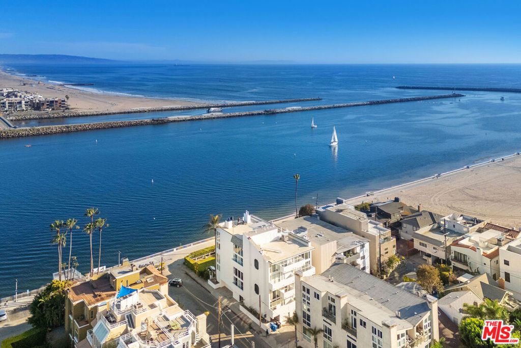 Soak up the head-on channel views and salty ocean breezes in this dreamy 3-bedroom + office, 4-bath townhouse just seconds from the sand! With floor-to-ceiling windows and soaring ceilings, the sun-drenched living room feels like a breath of fresh sea air. The open-concept chef's kitchen is perfect for laid-back dinners or impromptu beach brunches, and the wood floors throughout add just the right touch of coastal charm. Multiple balconies provide front-row seats to the sunshine, while a full bedroom suite downstairs makes hosting a breeze. Head upstairs via the spiral staircase to find more bright and breezy rooms including a second primary suite with yet another spectacular channel view. Tucked inside a secure building with 2-car tandem parking, this is your ticket to living the beach life in style. Sunset strolls, morning surfs, and marina vibes await! Minimum 14-month or longer lease required.