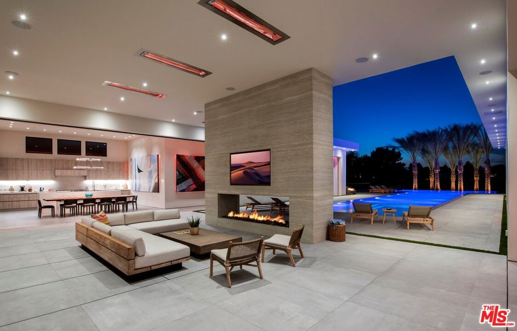 One of a kind stylish, cool and original family or friends mega-compound in the Madison Club with Approx. 10,000 SF under A/C and Approx. 13,500 SF under roof. Two luxurious master suites with his/hers baths and closets and 6 additional suites, two full Wolf kitchens - one is for guests, chef or large scaling entertaining. Total of 8 bedrooms and 11 beds. The compound features a pickleball court, an 80' zero edge pool, an oversized outdoor poolside movie screen, a covered patio with a see-through fireplace and an oversized motor court, carport and garages for a total of 20 car spaces inside the property with 10 of them covered/garaged. Top interior design with Italian cabinetry throughout and the finest materials.
