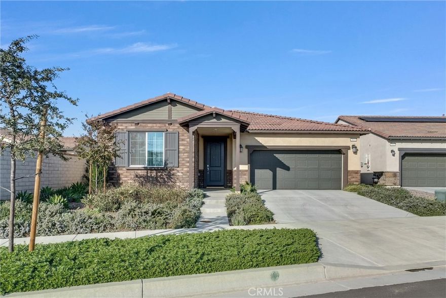 This beautiful end-lot residence is nestled within the gated Esperanza 55+ Active Adult Community, this beautiful single-story home is located in one of Ontario Ranch’s most sought-after master-planned communities, offering an elegant and high-quality lifestyle.
residents enjoy access to the impressive La Jolla Club, a spacious clubhouse designed for both relaxation and social gatherings. Community amenities include a resort-style swimming pool, bar area, outdoor entertaining kitchen ideal for hosting events, and fire pits perfect for evening get-togethers. The community also offers a fully equipped fitness center, pickleball courts, and a dedicated dog park.
This end-lot residence offers enhanced privacy compared to interior homes. The seller has confirmed with the HOA that the front yard may be enclosed with fencing, providing an excellent opportunity to create a more private and secure outdoor space.

The home has been used exclusively as the seller’s vacation retreat and has seen very limited use, presenting in near-new condition. It features fully owned solar panels, delivering long-term energy efficiency and utility savings.

Inside, the living area is highlighted by a stylish custom TV feature wall, adding a modern focal point to the space. The attached two-car garage is equipped with a pre-installed electric vehicle charging outlet, offering convenience for today’s lifestyle.

The backyard is a blank canvas, ready to be customized to suit your personal vision—whether for outdoor entertaining, relaxation, or low-maintenance landscaping. With thoughtful upgrades, privacy potential, and exceptional condition, this home presents a rare opportunity for comfortable and refined living in a premier 55+ community.
Enjoy a prime location that blends everyday convenience with exceptional accessibility. The home is within easy walking distance to The Station at Eastvale and the Goodman Center, anchored by Costco, and is also close to 99 Ranch Market for daily shopping needs. Major freeways I-60 and I-15 are just minutes away, offering effortless commuting, while Ontario Mills is a short drive away, providing a wide array of shopping, dining, and entertainment options.