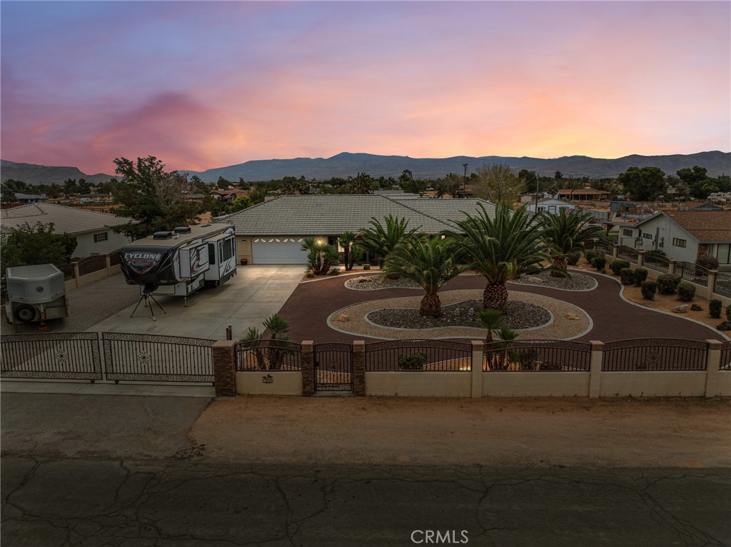 Absolutely Stunning Horse Property with Paid Solar & Luxury Upgrades! This incredible home boasts great curb appeal and a host of high-end features. Offering 4 spacious bedrooms, 3 full bathrooms, and 2,860 sq. ft. of living space, it’s the perfect blend of comfort and elegance. Step inside to the chef’s kitchen, designed to impress with new oak cabinets, granite countertops, a copper sink, top-of-the-line appliances, a massive walk-in pantry, and beautiful new tile floors throughout. The kitchen seamlessly opens to the living room, creating the ideal space for entertaining. The primary suite is a true retreat with soaring ceilings, a cozy fireplace, and private access to your backyard oasis. Upgrades can be found throughout, including new windows, ceiling fans, and more. The home is equipped with a 16.16 kW paid solar system (56 panels), dual Tesla Powerwall 28 kW battery backup systems, and a Tesla wall charger—bringing energy efficiency and peace of mind. Outside, enjoy a fully fenced yard with custom block wall and wrought iron fencing, artificial grass, and multiple outdoor living areas including a BBQ, firepit and lounge space. Additional highlights include a finished 3-car garage, two 40-foot storage containers with permits, RV/generator plug, RV parking, Horse stalls, above-ground spa, septic pump and cert on file, and more. This home truly has it all—luxury, function, and endless upgrades. A must-see property!