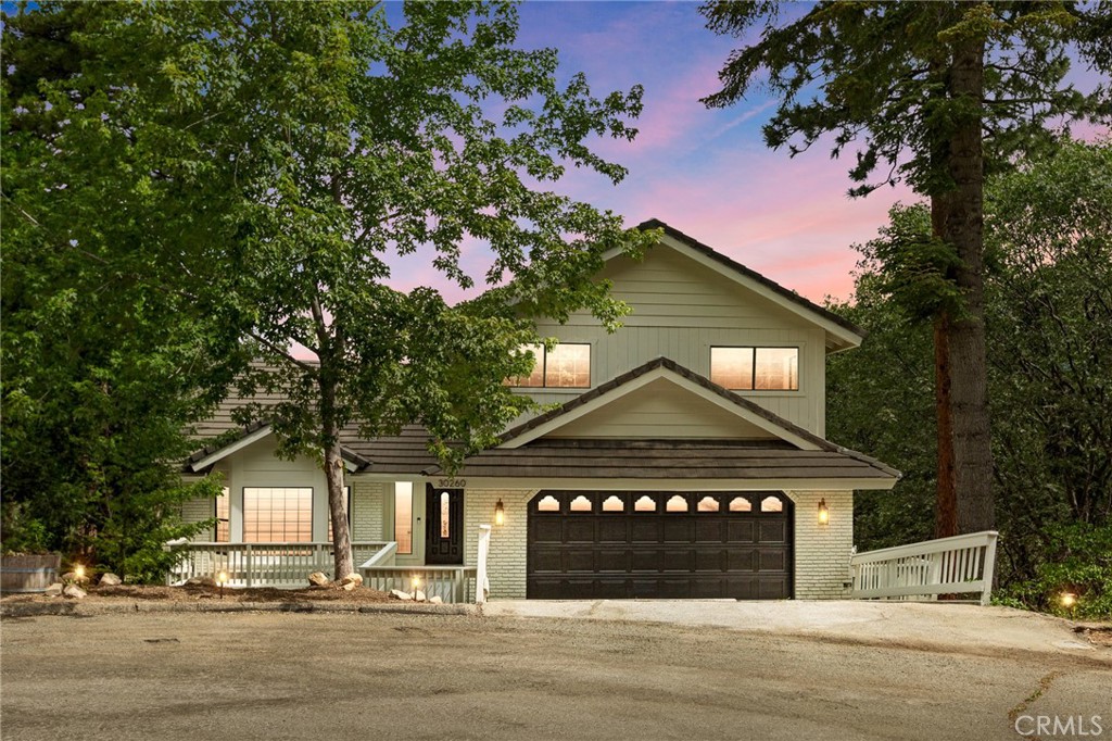 Located in the desirable area of Enchanted Forest Estates, this exquisite 3461 sq ft mountain tri-level home features 4 bedrooms and 3.5 baths nestled on a 14,560 sq ft lot at the end of a cul-de-sac. Three levels with beautiful views from every floor. The main floor entry to living room has valued ceilings and is open to the dining area. Canton Brook Oak waterproof vinyl plank flooring continues throughout the home. A gourmet kitchen awaits you with an 8 ft island, stainless steel trough sink featuring dual Kraus brushed brass kitchen faucets. Dolomite and black honed mist granite countertops, Zline professional grade range with black stainless-steel appliances make this kitchen an envy for any foodie. Family room with wood burning fireplace open to kitchen area. Deck off family room has a spa showcasing amazing mountain views. Mudroom with custom porcelain herringbone pattern tile adorn the floor extending into guest bathroom. Guest bathroom has a floating vanity with quartz countertop and custom backsplash with dolomite stone. The two-car garage with laundry on main floor.
Upstairs has two bedrooms with vaulted ceilings. Full bathroom with subway tile shower and circle marble mosaic tiles in the niche. The marble mosaic tiles adorn the threshold giving you fun custom touches. Primary suite includes a gas fireplace with beautiful stone wall, walk in closet, private deck with mountain views, bathroom suite featuring a soaker tub, and walk in shower.
If that wasn’t enough space the guest suite – game room could be used as a private apartment for income potential. This large bonus area has theater surround sound with a floating entertainment center and a black honed mist granite countertop. Kitchen / bar with apron sink with black honed mist granite countertops, 2 dual wine refrigerators, wall mounted wine racks and microwave. Bathroom with walk in shower features zellige tiles and marble mosaic tiles for the shower floor. The vanity has a reeded front with quartz countertop. This bottom floor has a large bedroom with that beautiful mountain view and walk in closet. Making up this bottom level is the 2nd laundry area spotlighting the custom gray and white Lenox porcelain tile floor. Central air-conditioning and heat. Fenced back yard with playhouse, picnic table, garden area and chicken coop are just some of the extra bonuses. Just minutes to the local ski resort and hiking trails making this magical getaway your next enchanted home.