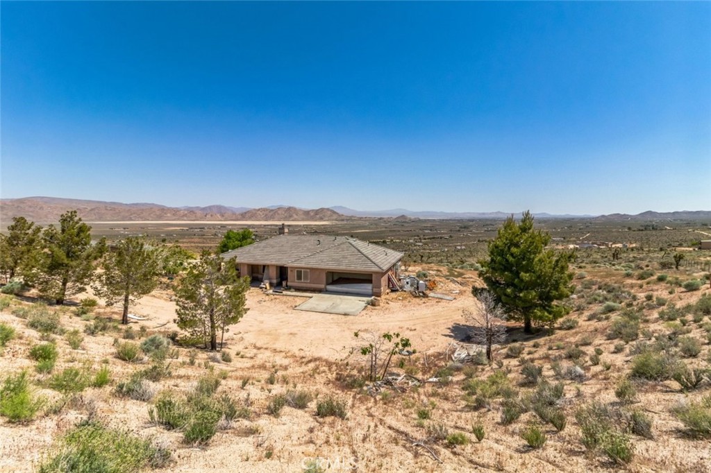 Amidst the serene landscapes of Apple Valley, is a property, brimming with potential, beckons those with a vision for creating their dream abode. Boasting 4 bedrooms, 2 bathrooms, and a promising space that could serve as an office or potential 5th bedroom, this retreat spans 1997 square feet, offering ample room for both relaxation and expansion. Inside, you're greeted by an atmosphere that whispers of opportunity. The home effortlessly flows from one inviting space to the next, promising comfort and convenience at every turn. With vast expanses of land awaiting transformation, the potential for realizing your dreams knows no bounds, especially with the detached structure that adds 1200 SqFt of potential living space. Whether it's cultivating a lush garden oasis, crafting a personal retreat, or simply reveling in the awe-inspiring sunrise and sunset views, this haven offers the canvas upon which to paint the life you've always envisioned. Embrace the beauty of mountain and desert panoramas, especially enchanting under the veil of nightfall, as you embark on a journey of endless possibilities in this secluded sanctuary.