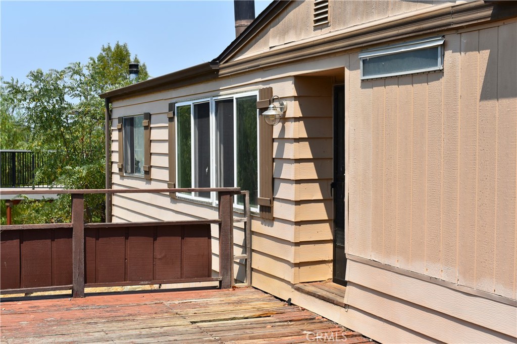 Opportunity knocks at this generous 8,200 sq ft lot nestled in the gated, lakeside community of Heritage Ranch on Lake Nacimiento. Positioned at the end of a quiet cul-de-sac, this 1977 mobile/manufactured home (approx. 1,152 sq ft; two bedrooms, two baths) sits on a permanent foundation, yet it is clearly in need of TLC
If you’re the type who sees potential where others see problems, this is your canvas: reenergize the existing structure, or install a brand new mobile home and take advantage of the expansive yard. The property features a large deck overlooking an open greenbelt and a hillside with a peek-a-boo view of the lake.
Lot Size: 8,200 sq ft lot – room to expand or completely redesign
Views: Greenbelt hillside and peek a boo lake view from private deck
HOA: Active homeowners’ association overseeing Marina, parks, patrol & community events
Best For: DIY renovator seeking value or buyer ready to reset with a new mobile installation
Lifestyle Upside: Full access to private amenities; tranquil, secure lakeside living
Heritage Ranch Resident Perks
Living here means membership in one of San Luis Obispo County’s most amenity-rich master planned communities:
• Private Lake Access & Marina - Boat ramp, courtesy dock, and “The Point” day beach area exclusively for residents. With a fish cleaning station on-site.
• Pools & Parks - Two pools (Heritage Park and Equestrian Park), pickleball, basketball, and tennis courts, a fenced dog park, playgrounds, and fitness trails. All meticulously maintained.
• Equestrian Center - 87 paddocks, trainer activities, boarding, and trail access for riders of every skill level.
• Campgrounds & Recreation Barn - RV and tent camping with hookups, event space with kitchen, and a community stage for gatherings.
• Senior & Community Programs - Heritage Village Senior Center supports multigenerational events, health screening, and social programming.
• Lifestyle & Atmosphere - A 9,000+ acre gated community with nearly 2,100 lots, preserved oak woodlands, open space, and 5,400 surface lake acres for boating, fishing, wakeboarding, and overall serenity.