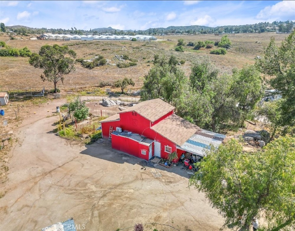 Privately situated manufactured home on a permanent foundation (Financeable). Property is fully fenced and offers a mini ranch is set up for horses, pigs, birds, dogs and possibly any other animals you may have. This manufactured home is spacious, has an open floor plan, with wood like vinyl planking and vaulted ceilings. In the barn there is 1 room that can be used as a mother-in-law quarters( current usage) and an additional drywalled room as well. Sellers are currently doing some renovations.Home sits at the rear of the property which allows a view of the entire property with a long tree lined driveway, 10x24 covered deck . The barn style shop is 20x50 and has water and electricity to it the 2 additional office spaces/rooms are attached to this . Horse amenities include a 85x148 arena, hay shed, 3 corrals with shelters, a couple of 60x60 small animal pastures. Also included is a nice metal carport measuring 24x40! Fruit trees include lemons, lime, pomegranates, apple, aloe Vera plants , wild rosemary, and pepper trees ! This home is on city water, propane and also has an older well on the property. The home is prewired for emergency power, you can just plug it into a portable generator. leach lines are roughly 8 years old.. Property is off paved Juniper Flats Rd.