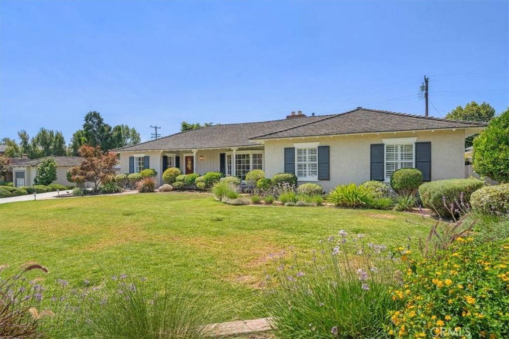 Welcome to 942 Volante Drive, a beautifully expanded and meticulously maintained home located in Arcadia’s sought-after Lower Rancho neighborhood. Situated on a generous 13,562 square foot lot, this residence offers approximately 2,610 square feet of living space with four bedrooms and three bathrooms in a thoughtfully designed layout. The inviting living room features a bay window with beautiful mountain views, creating a warm and welcoming atmosphere. The spacious primary suite is a true retreat with cathedral ceiling, offering its own fireplace, a generous walk-in closet, and a full bath. Two additional bedrooms are conveniently located nearby, while a fourth bedroom on the opposite side of the home provides excellent flexibility for guests, extended family, or a private office. At the heart of the home is a large, permitted family room with fireplace and attached office that opens seamlessly to the remodeled kitchen, appointed with granite slab counters, recessed lighting, and a Subzero refrigerator-freezer. A formal dining room adds elegance for special gatherings, while a nearby three-quarter bath offers convenience. All bathrooms have been tastefully updated with slab granite counters, high-quality faucets, and recessed lighting. Additional highlights include hardwood floors throughout, built-ins in both the office and garage, a newer tankless water heater, and ample storage. Outdoors, the property is an entertainer’s dream with a recently replastered pool featuring new tile and an energy-efficient variable-speed pump, a full outdoor kitchen with barbecue center, refrigerator, and fireplace, and a spacious private backyard ideal for gatherings or relaxation. The home is further enhanced by an automatic sprinkler system, a concrete driveway with electric driveway gate, and a two-car attached garage with electric door, recessed lighting, and custom built-ins. Combining modern upgrades with timeless design, this Lower Rancho gem offers both luxury and convenience, all within close proximity to top-rated schools, shopping, dining, and recreational amenities.