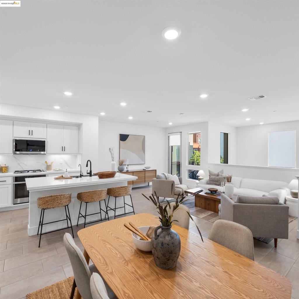 North facing 2-story townhouse-style condo in Dublin’s sought-after Boulevard community offers 3 beds, 3 full baths, and ~1,563 sq. ft. of thoughtfully designed living space. Built in 2021, it features soaring entry ceilings, modern flooring, and a first-floor bedroom with an en-suite—ideal for guests or a home office. The open-concept upper level is bright and airy with a spacious living and dining area. The upgraded kitchen boasts quartz countertops, white shaker cabinets, soft-close drawers, stainless steel appliances, and a gas range. The serene primary suite includes a walk-in closet and spa-like en-suite with a dual-sink vanity and oversized walk-in shower. Enjoy a peaceful retreat on your private balcony. Additional features include a 2-car tandem garage, laundry hook ups, water filtration/softening system, and reverse osmosis drinking water. Located just minutes from BART, top-rated schools, shopping, dining, and parks. Just a short walk to the Boulevard Recreation Center, which includes a heated pool, fitness areas, club facilities, and workspace. With thoughtful upgrades, a smart layout, and a prime location, this is an opportunity to own in one of Dublin’s premier communities.
