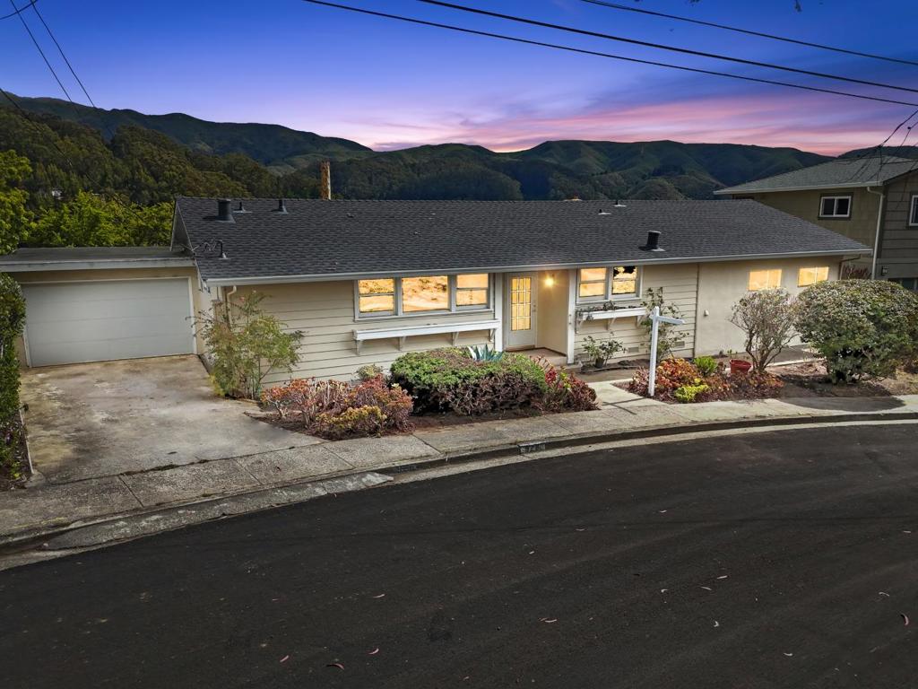 A tranquil setting with majestic mountain and valley views from this great home on a great street in sunny Linda Mar. Step inside and immediately experience natural light and the sweeping mountain scenery. Views from the large picture windows in the open living room concept accessible to the pet friendly spacious backyard, gardens, and expansive patio area. An addition accommodates the entertainment area and dining with a view. The kitchen was updated with wood cabinets and has enough room for a breakfast table. Invest in your future and unlock the incredible potential of this desirable location and make it your own. Come and create new memories at 928 Corona as this was a family home for 55 years. The expansive lot offers multiple opportunities for expansion or ADU. Within minutes of eateries, shopping, hiking trails, and the surf at the Pacific Ocean, Ideal Linda Mar location surrounded by views of nature in a serene setting. Seize this incredible opportunity in this great neighborhood, on a great street, in a great home.