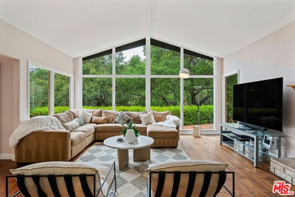 Charming Renovated Single-Level Home Nestled in the prestigious Hope Ranch community, this beautifully renovated single-level home offers refined coastal living paired with exceptional amenities. Residents enjoy exclusive access to miles of riding trails, tennis courts, and a private beach. Inside, the open floor plan centers around a spacious Great Room with a cozy fireplace and expansive floor-to-ceiling windows that flood the space with natural light. The gourmet kitchen is a chef's dream, featuring stainless steel appliances, a wine refrigerator, a large breakfast bar, and abundant storage. Generous living and dining areas flow seamlessly onto a large, sun-drenched entertaining terrace complete with an outdoor fireplace & BBQ ideal for year-round gatherings. The private primary suite opens to a secluded garden spa, creating a serene retreat. Two additional bedrooms offer peaceful views of the lush gardens and mature trees. An upper garden terrace provides stunning mountain views, adding to the home's tranquil charm.