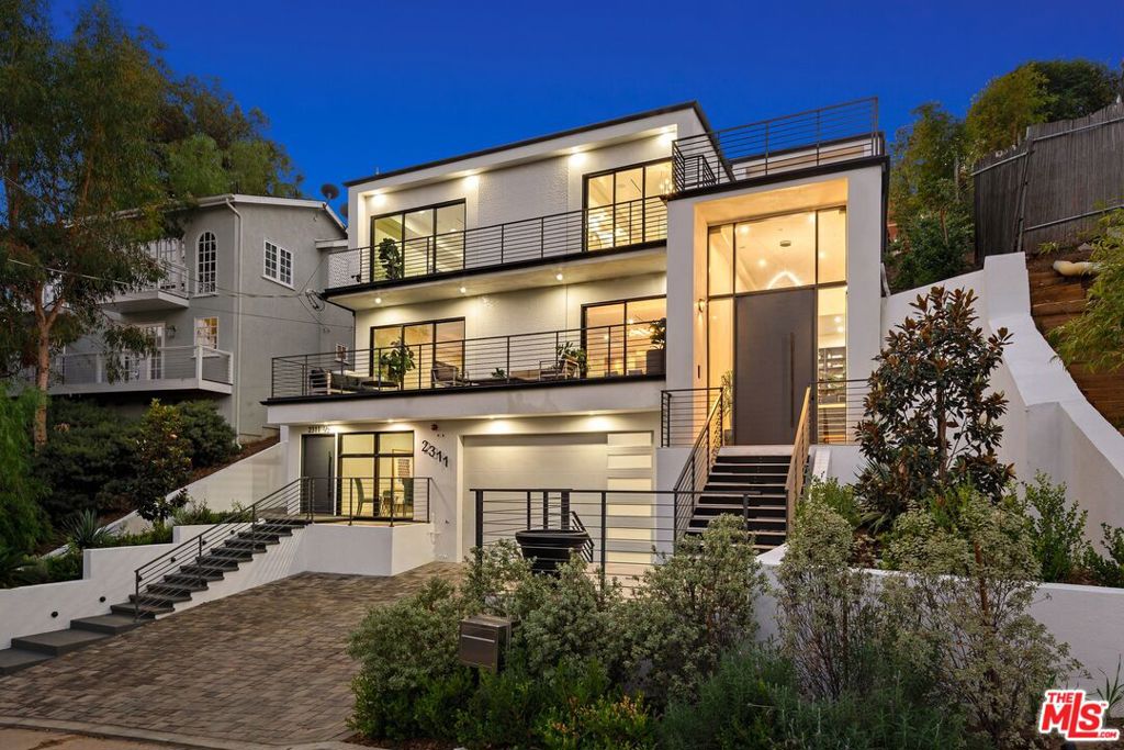 2311 Vasanta is an iconic Beachwood Canyon property offering an exquisite Hollywood Hills experience from the moment you step inside. This architectural gem greets you with a modern staircase inviting you to step into the great room and enjoy the stunning views of the Hollywood Hills while being nestled in the quiet coveted neighborhood of Beachwood Canyon. The main house offers an open floor plan, beginning with a library area which melts into a great room featuring dining area, modern kitchen, marble island, bar, fireplace, wine storage and a large entertaining space wrapped in a magnificent balcony with outdoor entertaining areas and magical views. Ascend the open staircase to the second level and you will find three bedrooms, a second outdoor entertaining terrace and an open den area featuring built in desks. When you open the door to the master bedroom you will be stunned by a space that looks and feels like a 5 star hotel complete with balcony, two master closets a free floating bath tub and a gorgeous walk in rain shower, bordered by exquisite tile and views of the Hollywood sign and Beachwood Canyon. Allow yourself to walk through the den and discover the two guest suites, each offering their own en suite bathrooms and wonderful views. Return to the den and slide open the floor to ceiling windows where there is natural room to perform as host, or escape to your own sanctuary. Elevate on the last flight of stairs where 2311 Vasanta offers you one more surprise, a swimming pool and hot tub, situated atop the property where you can experience Hollywood's "Magic Hour" while soaking in the views of one of California's most iconic canyons. The stunning house offers an additional guest studio that is attached to the main house, with a separate address. This studio has its own private entry and includes a kitchen area and private bathroom.The residence also offers a driveway that fits three cars and a garage for two vehicles.