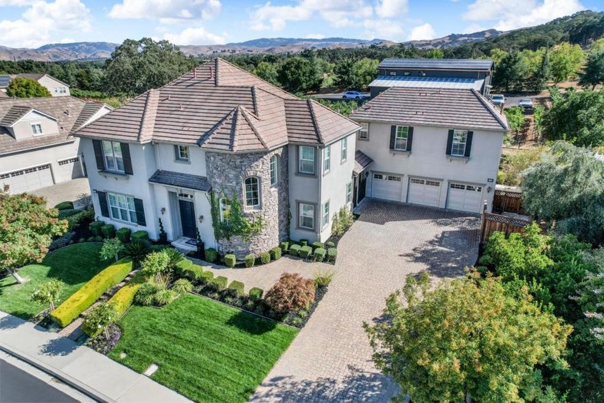 Best price per square foot in the area. A huge price drop. hurry before this one is gone. Stunning home in a prestigious Pleasanton neighborhood next to Ruby Hill winery with beautiful views of vineyards. This thoughtfully designed luxury home flows seamlessly throughout. Step inside to a stunning entry leading to a family room and kitchen combination that's a chef's delight. White cabinets, Wolf appliances, Quartz and Quartzite countertops, with ample room for entertaining small family gatherings or large parties. Downstairs, enjoy the luxury of a large bedroom with an ensuite bathroom and additional room perfect for an office or seventh bedroom. Upstairs the thoughtfully designed primary bedroom has a large custom his and her closet and serene spa like bathroom. Above the detached three car garage is a bedroom, kitchen, laundry, and bathroom with separate address, a perfect ADU for rental or a guest house. The neighborhood, surrounded by a 14 acre vineyard and newly restored barn, is splendid for leisurely family strolls and the Pleasanton Trail is steps away from front door. Enjoy a year round Farmers market, summertime music in the park, shops and an array of restaurants in charming downtown Pleasanton all just minutes away. Amazing deal for this area of East Pleasanton.