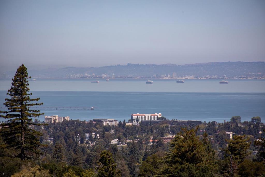 Completely transformed with a sophisticated modern aesthetic, this Hillsborough home showcases sweeping and spectacular Bay and San Francisco skyline views. High end down to the studs remodel in 2013 with no expense spared. Located in the coveted Lakeview neighborhood on just over one-half acre, features a striking two-story facade and generous outdoor spaces designed for entertaining around a sparkling pool, elevated spa, fire pit, and view decks. Inside, a dramatic double-height foyer highlights a sculptural staircase with glass panels and a wine display wall. Soaring ceilings and a two-story wall of windows frame the views in the open living and dining area with elevated gas fireplace and statement chandelier. The chefs kitchen offers lacquered cabinetry, quartz-wrapped island with glass counter seating, premium appliances, walk-in pantry, and adjoining casual dining area with banquette and family room that opens to the deck. Five bedrooms including one on the main level ideal for an office, plus a luxurious upstairs primary suite with fireplace, balcony, sitting area and spa-inspired bath. Smart home automation, air conditioning, and epoxy-finished large garage add modern convenience. Excellent Hillsborough schools with easy access to Highway 280 and downtown Burlingame.