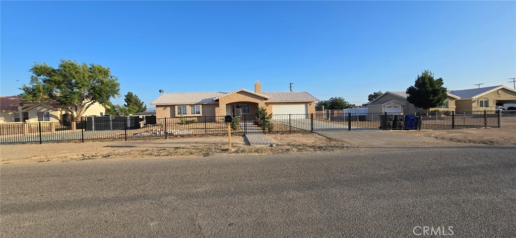 Beautiful Turnkey single story home on over a half an acre. Fully Fenced with Gated entry! Nicely landscaped front yard with brick walkway and extension concrete driveway. Enter through the covered Front porch entry way into the open floor plan 3 bedroom 2 bath home. Features include: ceiling fans throughout home, New flooring, Freshly painted interior, open kitchen with large eating area, granite counters, and new Gas range, master bath has granite counters, Dual Pane windows with blinds, large family room with fireplace. Relax under the covered patio. The huge backyard is an empty canvas waiting to be created.