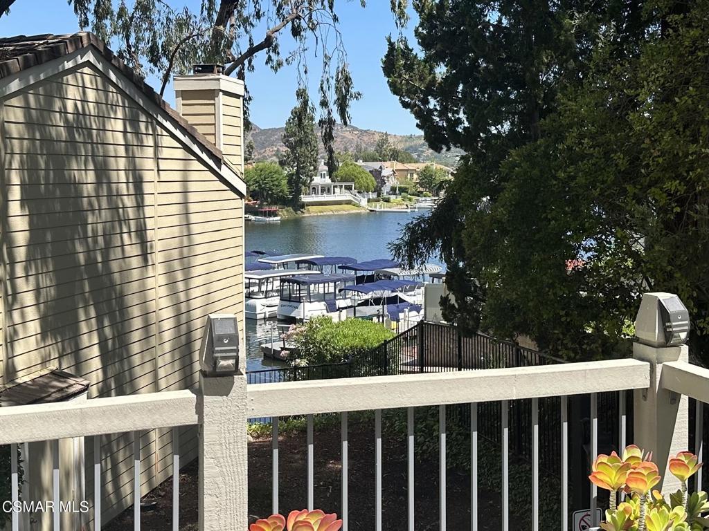 PRIVATE, end unit with VIEWS of stunning Westlake Lake! The expanded floorplan features 3 bedrooms, 2.5 bathrooms, and 2 ATTACHED, ENCLOSED garages - rare for Westlake Bay! Enjoy the updated kitchen with stainless steel appliances, granite counters, custom cabinets, pendant lighting, countertop seating, and decorative backsplash. Light-n-bright living room has lofted ceiling and a corner fireplace, and two sliders take you to the huge, wrap-around Trex balcony for easy entertaining and boat admiring. Hardwood floors grace the family room and office/den too. Primary bedroom has peek-a-boo view of the lake, charming white-washed floors, recessed lighting, and custom walk-in closet. Sophisticated primary bathroom features marble floors, custom glass dual vanity, sleek shower stall, and impressive Italian wall tile. Two bedrooms use an updated hall bathroom, complete with custom vanity with marble countertop, shower-over-tub, and designer tile walls. Laundry room with storage cabinets. Remodeled powder bathroom at entry. Westlake Bay offers lakefront viewing terraces to relax on, 2 recently-refinished pools, a spa, ample guest parking, and a clubhouse with a gym, kitchen, pool table, and a 90-inch TV. Award-winning schools, beautiful parks, fine dining & shopping, and trails nearby. Refrigerator, washer and dryer, water, cable, and trash service are included with lease. Available July 25.