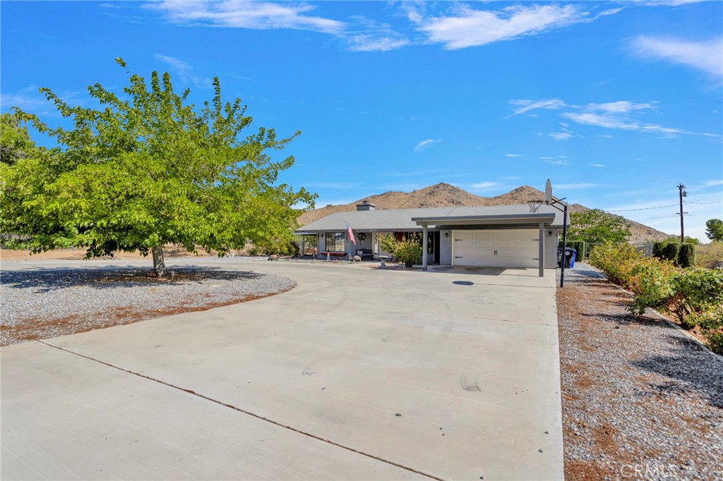 Located on Corwin Road this location is highly desirable for being close to the 15 freeway, the hospital, Super Target shopping center and many dining options. Arriving here you will love the large U shaped driveway that could easily fit 10 cars, the mature trees and rock landscaping for easy maintenance plus the covered parking in front of the garage. Entering the home you have designated rooms that provide space for the whole family. Living room has a beautiful fire place for cozy winter nights, plus a door that leads out to the garden. There's a formal dining room plus the dining space off the kitchen. The kitchen is spacious with a island that gives you more countertop space and storage. The additional living room offers you even more space- an office, extending the primary bedroom, play room for the kids, gym, etc.. whatever you may need the extra room for, it's available! Down the hall is a bunch of cabinets giving you plenty of space for storage. The 2 guest bedrooms are generously sized and full size guest bathroom. The primary bedroom is spacious with a large bathroom, walk in closet, and separate toilet/shower room. The back yard truly has endless possibilities. The main section is fully fenced with privacy chain link fencing, has a patio and large cement area perfect for entertaining. The additional backyard space is also fully fenced, has mature trees and bushes, and a storage shed and then the garden area is fenced separately which has it's own access to the house. There's room here to finish the yard however you'd like! Add a pool, build an ADU, etc. The spacious garage also has the laundry hookups, utility sink, and storage options