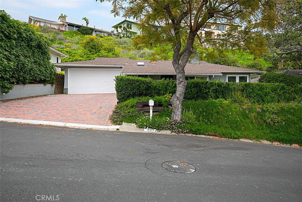 Updated 2 bedroom (plus den!), 3 bathroom family residence in Laguna Beach, located in beautiful Blue Bird canyon surrounded by dramatic natural vistas unique to Laguna Beach. Charming curb appeal, contemporary finishes in all bathrooms, recessed lighting and central A/C make this home a rare find in Laguna Beach. Newer wood laminate flooring, paint and updated kitchen with stainless steel appliances for easy everyday living. Private front yard with a picnic table featuring built-in grill is great for entertaining! Laguna Beach trolley takes you to Laguna's scenic beaches and downtown restaurants/shops. Convenient to Bluebird Park with tons of play area for the little ones. Short drives to nearby Laurel Canyon Wilderness Park/Trails and Crystal Cove State Park. Note: Refrigerator, washer and dryer are not included and photos show previous staging furniture.