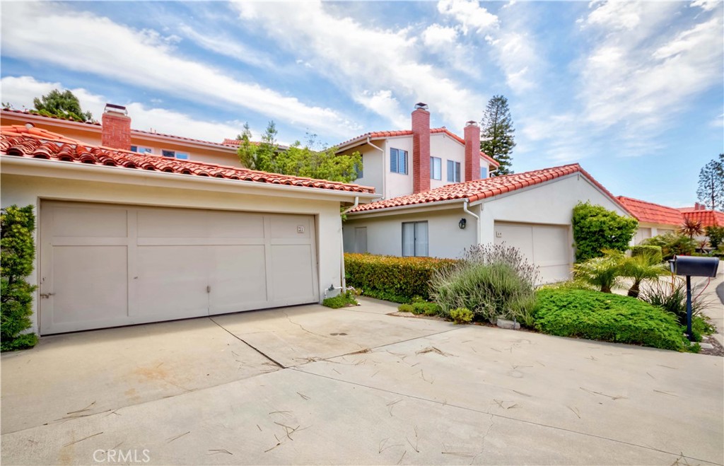 Feels like a single-family residence. This wonderful 2-bedroom home also features a family room that can serve as a home office or a cozy sleeping nook—the owners have even hosted guests there—in the highly desirable Casas Verdes complex in Rolling Hills Estates. The living room opens up to a lovely patio/backyard and a formal dining area. The master bedroom includes its own bath, a large closet, ample storage. A cozy den with French doors and a heartwarming fireplace adds charm. The beautiful kitchen features remodeled appliances, a breakfast bar, and a dining area. There is a 2-car garage with a long driveway. The small community offers a pool, clubhouse, and park. The HOA has installed a new roof and gutters, painted the exterior of the building, and maintained the tile roof. Great floor plan with hardwood floors throughout, and all windows are adorned with shutters.