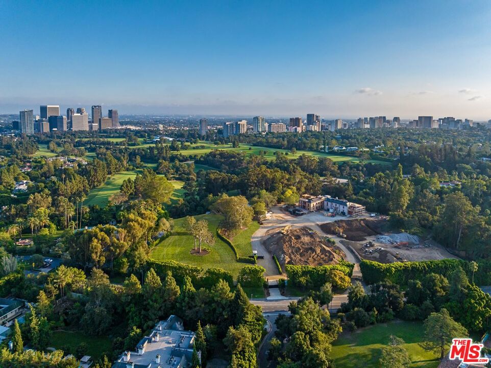 South Carolwood offers a remarkable development opportunity on approximately 2.25 flat acres. Nestled adjacent to Los Angeles Country Club, this site is one of the last remaining lots to offer utmost seclusion in Holmby Hills on a private street with a view of the illustrious and expansive golf course, as well as views of Century City. The property is conveniently accessed off of Sunset Blvd, with plans for the installation of a private signal to control traffic in all four directions (East/West on Sunset and North/South at Carolwood). What truly sets this property apart is its flat sprawling development space surrounded by a number of mature trees that adorn the site. Some of these majestic trees have graced the grounds for over 50 years, providing a lush and verdant landscape that is virtually irreplicable on other properties. The presence of such a breathtaking natural setting enhances the property's appeal, creating an environment that fosters a profound sense of connection with nature and the history of the land. The site is already thoughtfully graded, resulting in limited site development costs, making it an ideal canvas for an extraordinary estate. Plans and renderings have been completed by Scott Mitchell and Mark Rios and include a 14,670 square foot main residence as well as a pool cabana, sports lounge, pickle ball court and padel court for the racquet enthusiasts and two two car garages. This property is truly a once-in-a-lifetime opportunity to own a piece of Los Angeles history and create a private sanctuary with unparalleled views, extraordinary privacy, and an enchanting forest of mature trees, traffic light access to Sunset.