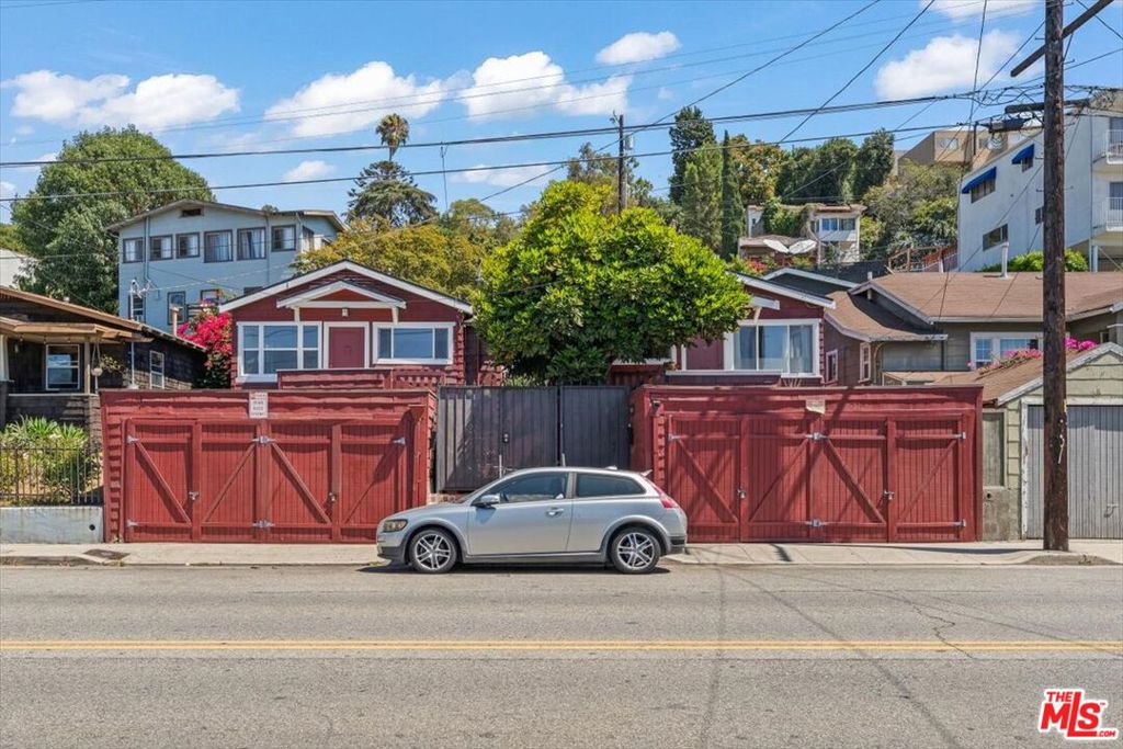 Two classic storybook cottages in prime Silver Lake, just blocks from Sunset Junction. Built in 1924 and rich with character, 1248 & 1250 Hyperion feature beadboard ceilings, hardwood floors, and updated kitchens and baths that honor the homes' era. Westerly views sweep across the Griffith Park hills to the Observatory and Hollywood Sign. Each home enjoys its own two-car garage and an easy indoor-outdoor flow: the kitchens open to a generous, gated grassy backyard with room to dine, garden, and gather. Classic bathrooms feature timeless fixtures with tub/shower combos, while both updated kitchens offer ample storage. Approx. measurements: 1250 Hyperion ~468 sq ft; 1248 Hyperion ~648 sq ft (buyer to verify). A rare opportunity for an investor or end-user: live in one cottage and offset the mortgage with rental income from the other. Historic charm, everyday livability, and a "heart of Silver Lake" location, this is the duplex you've been waiting for.