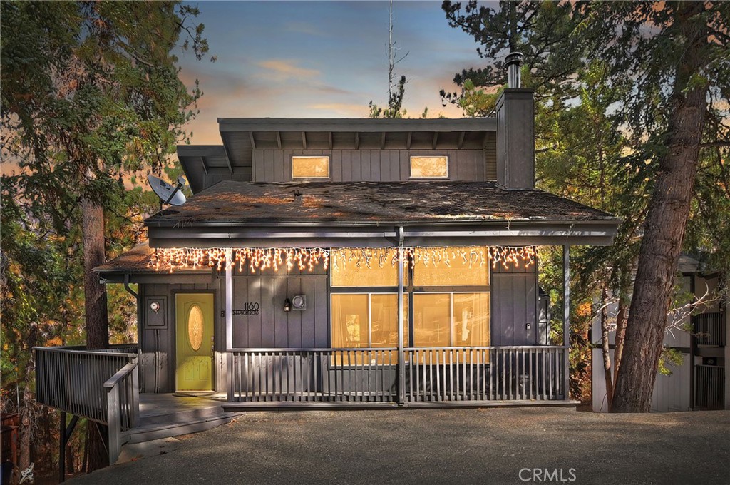 Prepare to fall in love with this dreamy Moonridge retreat! This mountain home delivers a true WOW—The stunning floor-to-ceiling native stone fireplace is truly breathtaking as the heart of the Great Room, gracing the open kitchen and dining area with its warmth & timeless rustic charm. Vaulted ceilings and expansive windows bathe the room in natural light, and the magic of the changing seasons, displays the beauty of fall colors and crisp falling snow. Offering 1,759 sq. ft. with 3 beautifully curated bedrooms, 2.5 baths and a highly desirable game room/den boasting a pool table and direct access to the lower deck and spa area. The open kitchen shines with a butcher-block island that doubles as both a prep station and casual dining spot. The charming coffee bar is wonderful for jump-starting your day or preparing a warm beverage to savor by the fire on cold winter nights. Warm wood detailing with open beams & plank-wood-style flooring, thoughtfully chosen furnishings and artful lighting & chandeliers infuse an added touch of mountain enchantment. Enjoy the sights and sounds of nature from one of the home’s 3 outdoor gathering spaces. The covered front porch provides protection from the elements, and the expansive upper wrap-around deck is an amazing space for outdoor dining and BBQs amid the lovely, forested setting. The lower deck leads to the large spa, nestled in the serenity of nature and a spacious open area, great for building a snow man & outdoor adventure. In addition to the Great Room, the main floor also has a mud-room entry, ¾ bath, convenient laundry room and a walk-in style storage closet. There's room for a crowd, upstairs offering an inviting guest bedroom, a convenient half bath and a large bunk room! Downstairs, the spacious primary bedroom offers a restorative retreat, multiple closets and direct-access to the dual-entry full bathroom. Fresh exterior paint gives the home crisp curb appeal, while level parking and good sun exposure make winter visits wonderfully simple. Located just minutes from Bear Mountain, Snow Summit, the golf course, zoo, & trails, this fantastic Moonridge location provides wonderful access to outdoor recreation. The lake, markets & Big Bear’s Village with shopping and dining are just a short drive away. Whether you’re looking for a weekend escape, full-time home or income-producing short-term rental, this Moonridge sanctuary offers a rare combination of natural beauty, inviting warmth and year-round enjoyment.