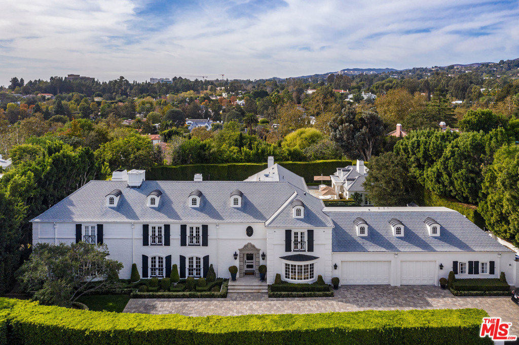 This gated classic traditional estate is located on one of the most coveted streets in Holmby Hills. Surrounded by mature hedges and a 12' solid gate, thepropertyboasts extreme privacy. The first floor has a formal 2 story entry with a grand staircase, parlor, formal living and dining room, sunken media room including a custom metal wrapped bar with onyx counters, and a private office featuring an ivory crocodile ceiling and black lacquered cabinetry. Two formal powder rooms and a spacious gourmet kitchen with breakfast and family room complete the first floor. French doors surround this classic design and open up to the expansive park like grounds with a pool, spa, 2 bedroom guesthouse and separate 2 bedroom staff quarters. On the second floor, there is an impressive master suite with an enormous balcony overlooking the backyard and 4 additional bedrooms. 219 S Mapleton exemplifies classical architecture and will appeal to a buyer with an affection for quality and taste.