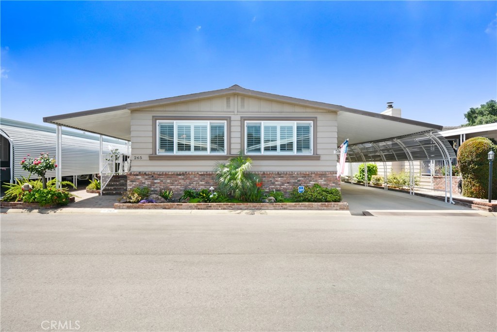 Double-Wide Beauty in Twin Oaks – 55+ Community in La Verne | North-Facing View!
Welcome to Space 265, a stunning 2-bedroom, 2-bathroom Silvercrest double-wide located in the highly desirable Twin Oaks 5-Star Senior Community in La Verne. This beautifully upgraded home offers a spacious and open floor plan with 1,440 sq. ft. of thoughtfully designed living space and a north-facing orientation that brings in lots of natural light
This home is filled with unique and desirable features, including drywall throughout, crown molding, recessed and track lighting, dual-pane windows, custom shutters, and a combination of plush carpeting and durable vinyl flooring.
The remodeled kitchen is a true showpiece, featuring marble countertops, a charming garden window, a center island, built-in microwave, and gorgeous custom cabinetry—perfect for the home chef or entertainer at heart.
The layout includes a spacious living room, a family room currently used as a home office, and two well-appointed bedrooms. The primary suite is a private retreat with mirrored closet doors, a remodeled en-suite bathroom, featuring a separate soaking tub and a beautiful walk-in shower. The second bedroom also includes mirrored closet doors and direct access to a second full bathroom, conveniently located near the indoor laundry room.
Step outside to a semi-private, all-brick front porch with elegant wrought iron railing, a perfect place to sip coffee and take in the views. Just off the porch is a generously sized back patio, ideal for BBQing, gardening, or relaxing in the California sunshine.
The home is beautifully landscaped with low-maintenance features, and the extended covered carport offers parking for multiple vehicles plus a large shed for additional storage.
Twin Oaks is a premier 55+ community offering exceptional amenities, including a clubhouse, pool, spa, fitness center, sauna, billiards room, card room, and large multi-purpose room for social events. Located near shopping, restaurants, hospitals, public transportation, and major travel routes—this is senior living at its best.
* Don’t miss this one-of-a-kind home—call now to schedule a private showing!
** Home is on REGISTRATION – No Property Taxes!** New Space Rent Per Park is $757.31.