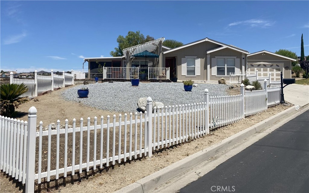 Professional photos will be added by 7/29. AMAZING VIEWS with 2,040 sqft of living space in this coveted 3-bedroom 2-bath house, sitting on a large lot offering an abundance of privacy. This beautiful home comes with a 2-car garage and NO Space Rent because you own your land, and it is 433A certified so it is financeable. Chefs, enjoy the large, spacious kitchen with cabinets galore and a breakfast nook looking out over the canyon with endless scenic views. Enjoy those cool winter days in front of your wood-burning fireplace in the large open living room offering ample sunlight. The spacious owner's suite includes a sitting room/retreat area. Enjoy lots of storage with two master suite closets. One is an oversized walk-in closet with shelving; the other closet has built-in drawers and shelving. The private owner's bathroom has dual sinks and a separate shower and soaking tub. As a bonus, this home offers a screened-in lanai overlooking the beautiful canyon and evening sunsets. Plus, there is an additional room off the master suite with endless possibilities, such as a workout room, a craft/hobby room, an office, etc (neither of these additions are included in the 2040 sqft). Located in a vibrant 55+ community, Warm Spring Knolls Association includes clubhouse, pool, spa, gym, banquet facility and more! Over the past few years, owner has spent over $50K on renovation and upgrades, such as interior paint, new carpet, fans, faucets, garbage disposal, etc. Completed in 2024: new A/C, Plantation shutters, whole house water filtration system, water heater. Great location with ample shopping and dining nearby; close proximity to the 215 FWY and 15 FWY.