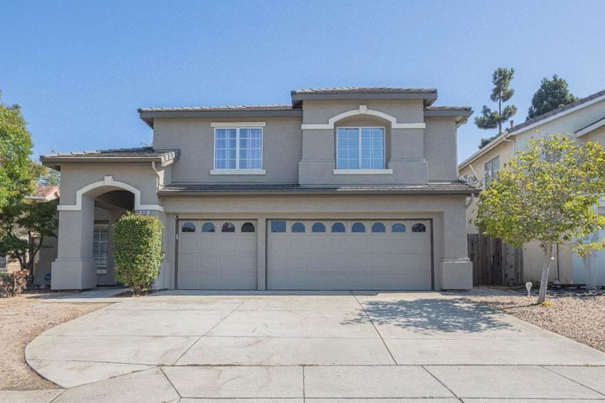This beautiful 2384 sq ft home features four bedrooms and 2.5 baths, including a spacious ground-floor primary bedroom suite with a walk-in closet, sitting area, and a large bathroom. The kitchen is a chef's delight, equipped with granite countertops, a double oven, a gas range with a custom updraft exhaust, and a touchless faucet. Enjoy the flexibility of multiple dining options, including a breakfast bar, breakfast nook, and a formal dining area in the living room.  The home boasts a separate family room with high ceilings and a fireplace, providing a cozy ambiance. The flooring combines carpet and tile, offering both comfort and durability. Other amenities include a utility room with a washer and dryer, a three-car garage, dual-pane windows, and more. The entertainers' back patio is equipped with everything you need for an enjoyable family gathering, allowing you to sip and savor while relaxing under the lights.  This home seamlessly combines functionality and style, making it perfect for any family.
