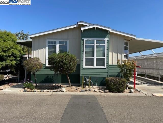 Manufactured home in desirable Georgian Manor. This home has: 3 bedrooms; 2 full baths; kitchen with island, nook, and lots of cabinets; formal dining room; living area with wood burning fireplace; primary suite with walk in closet and private glamour bath featuring soaking tub and stall shower; new blinds; laminate flooring in all living areas; 9" flat ceilings throughout; extra wide carport; rare back yard space, large shed & more! Fireplaces: LIV,WOD,